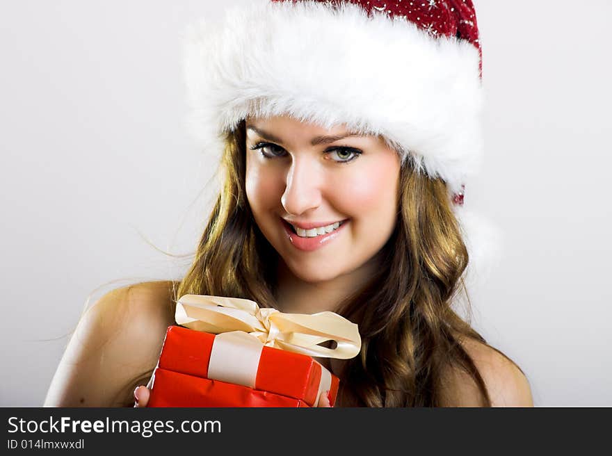 Winter portrait of a beautiful young smiling woman with a christmas cap. Winter portrait of a beautiful young smiling woman with a christmas cap