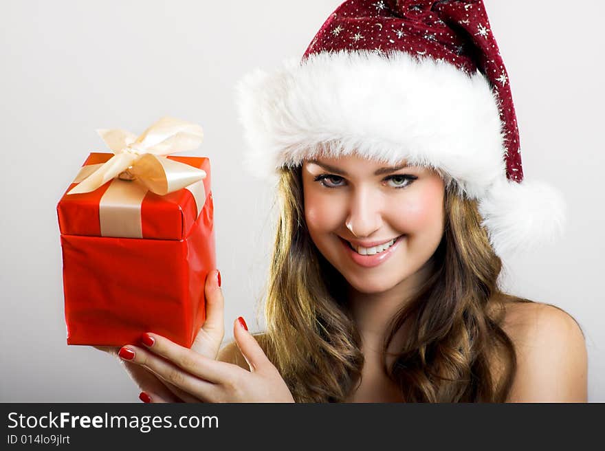 Winter portrait of a beautiful young smiling woman with a christmas cap. Winter portrait of a beautiful young smiling woman with a christmas cap