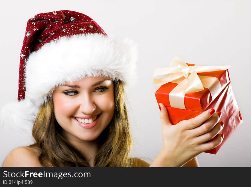 Winter portrait of a beautiful young smiling woman with a christmas cap. Winter portrait of a beautiful young smiling woman with a christmas cap