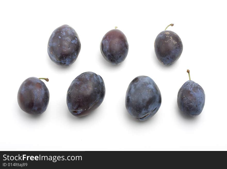 Fresh plums on white background