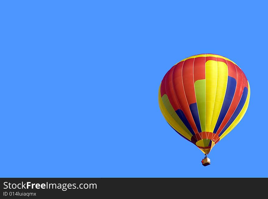 Colored Hot Air Balloon on solid blue sky background