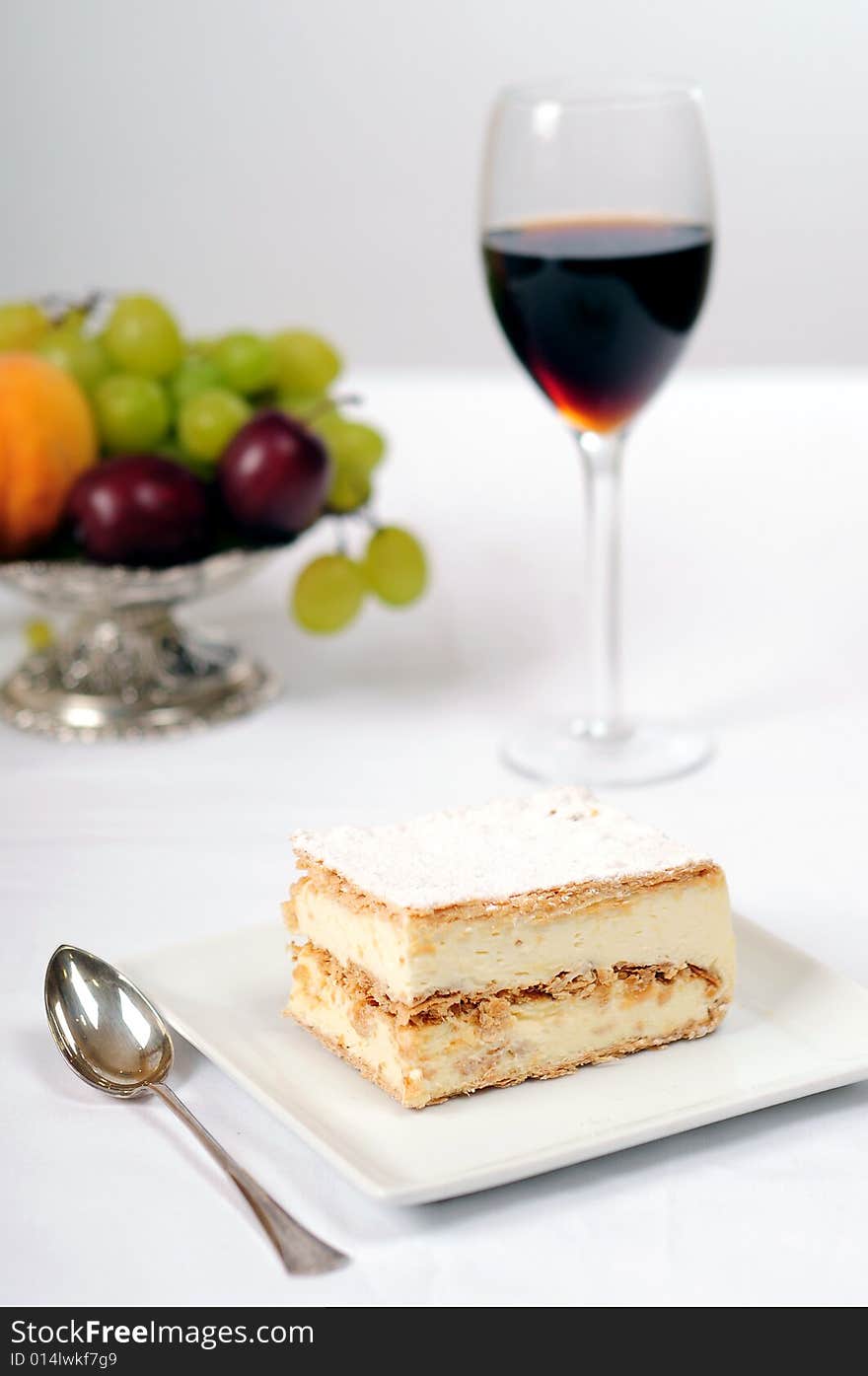 A view with a piece of cake over white background