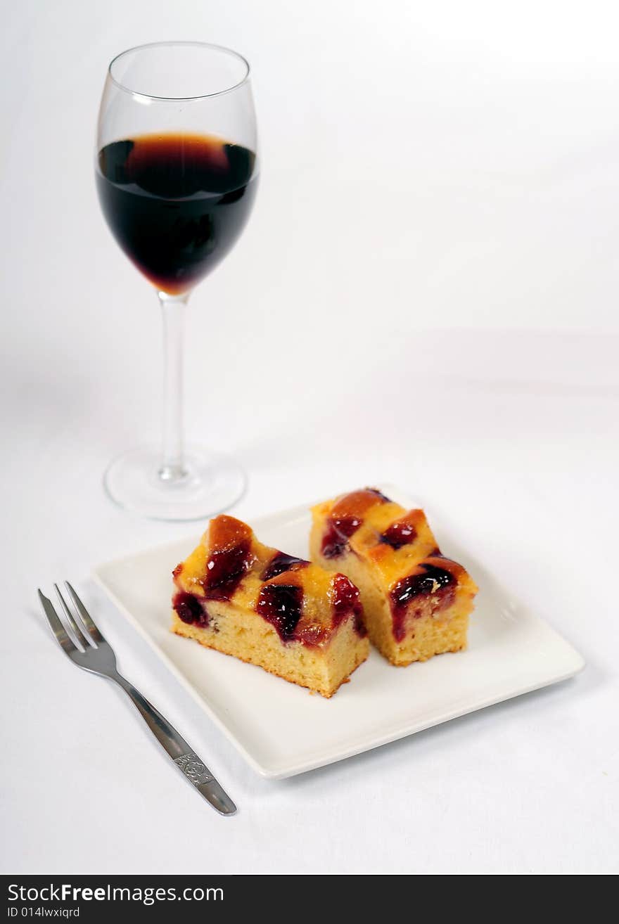 A view with a piece of cake over white background