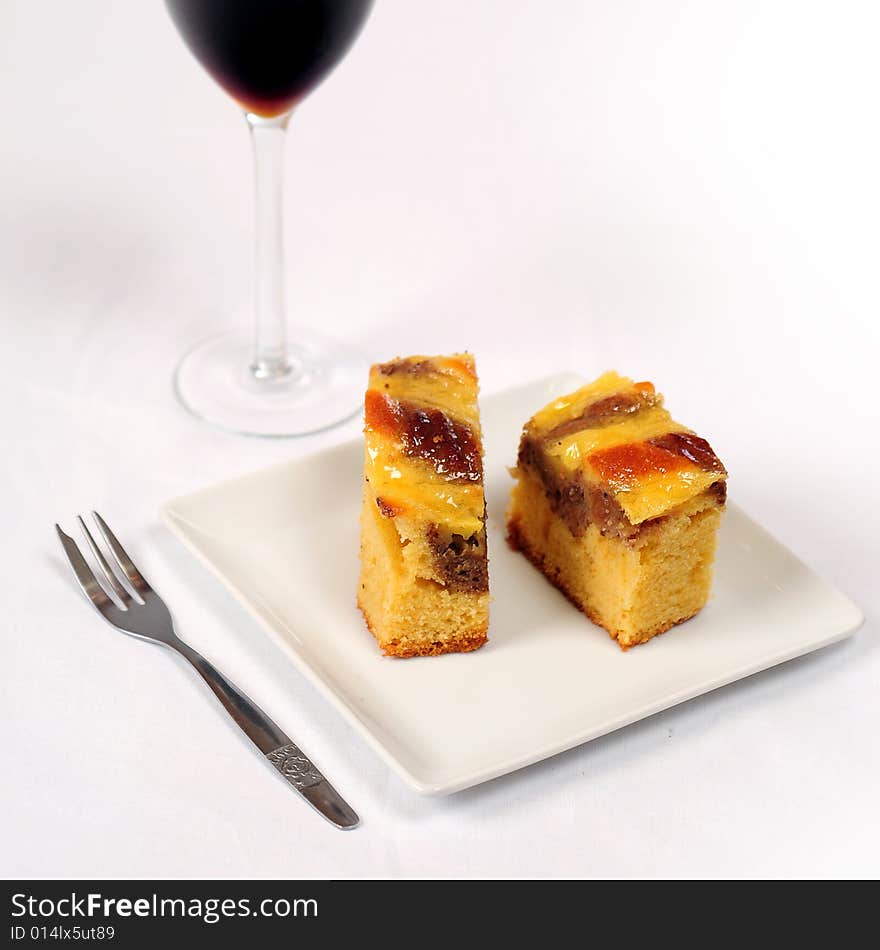 A view with a piece of cake over white background