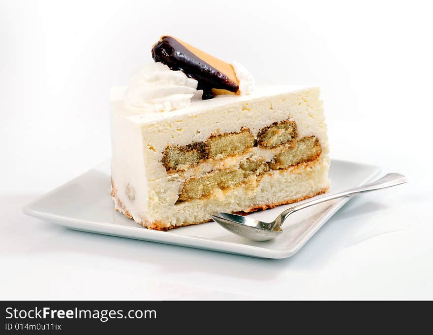 A view with a piece of cake over white background