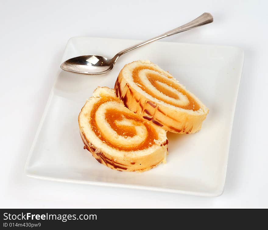 A view with a piece of cake over white background