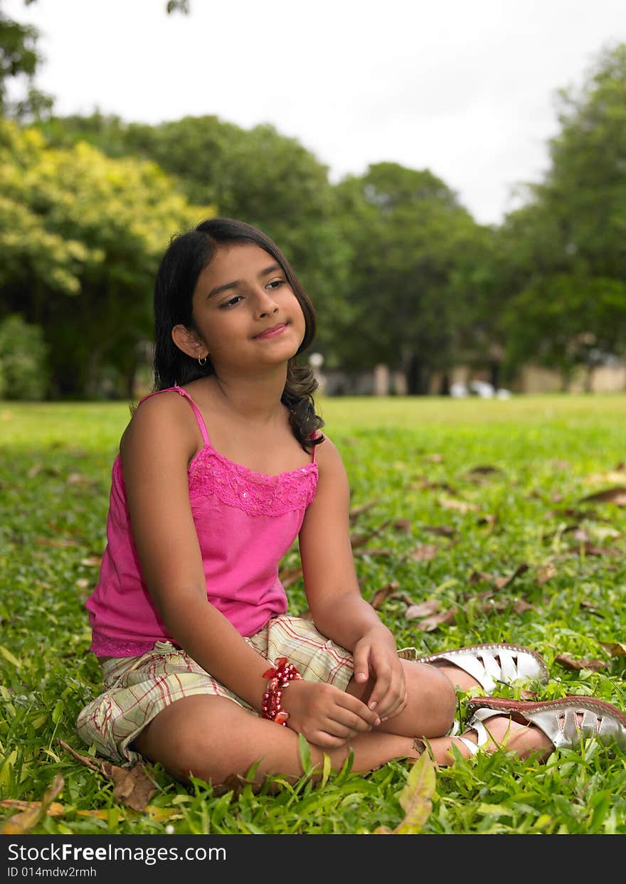 Asian girl sitting in a park