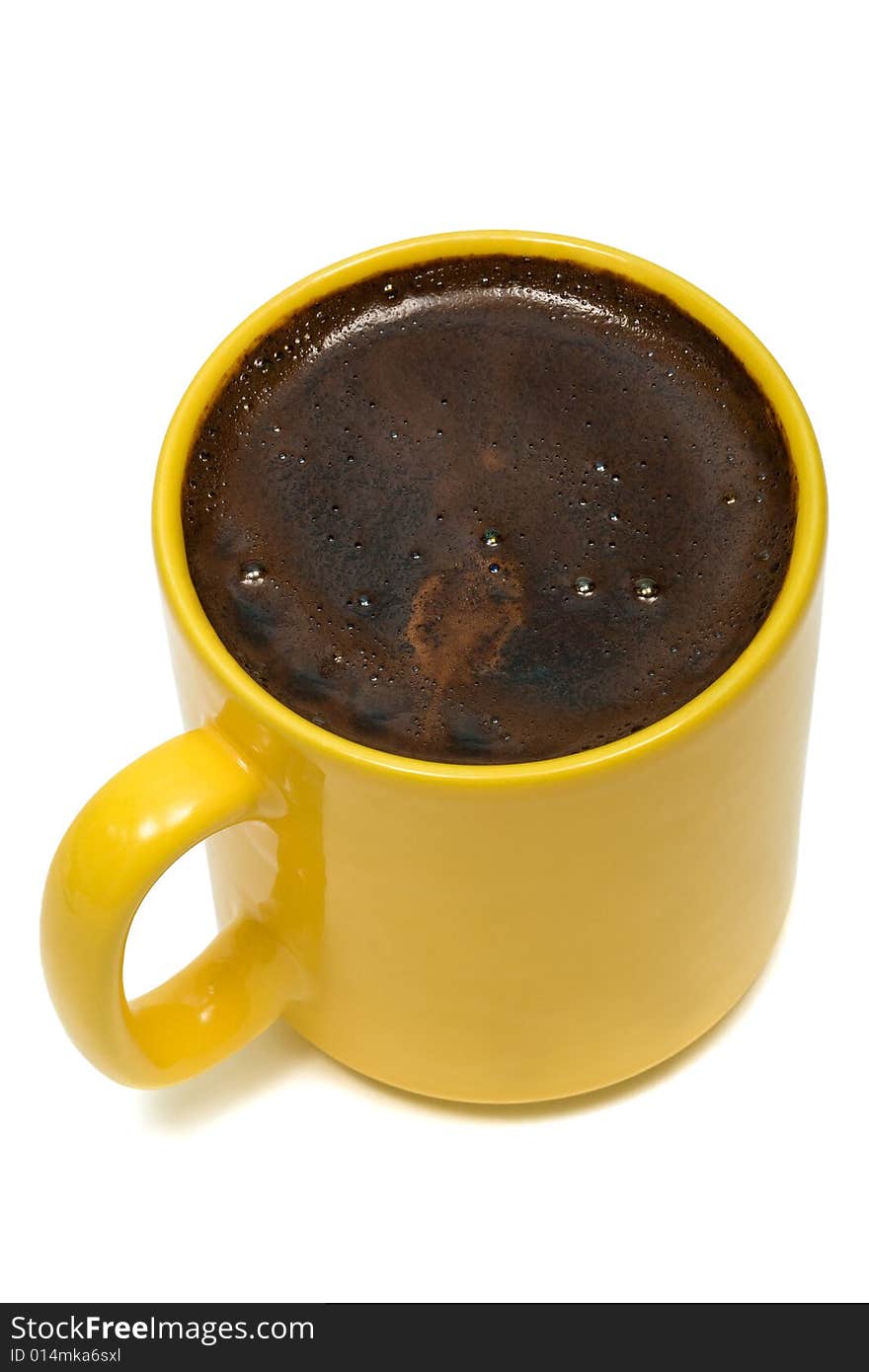 Yellow mug from coffee on a white background