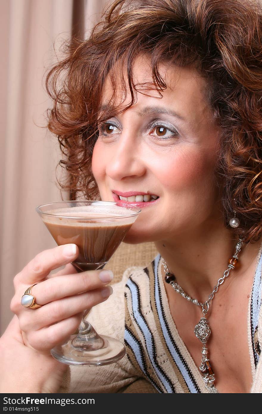 Mature female with a chocolate drink in her hand