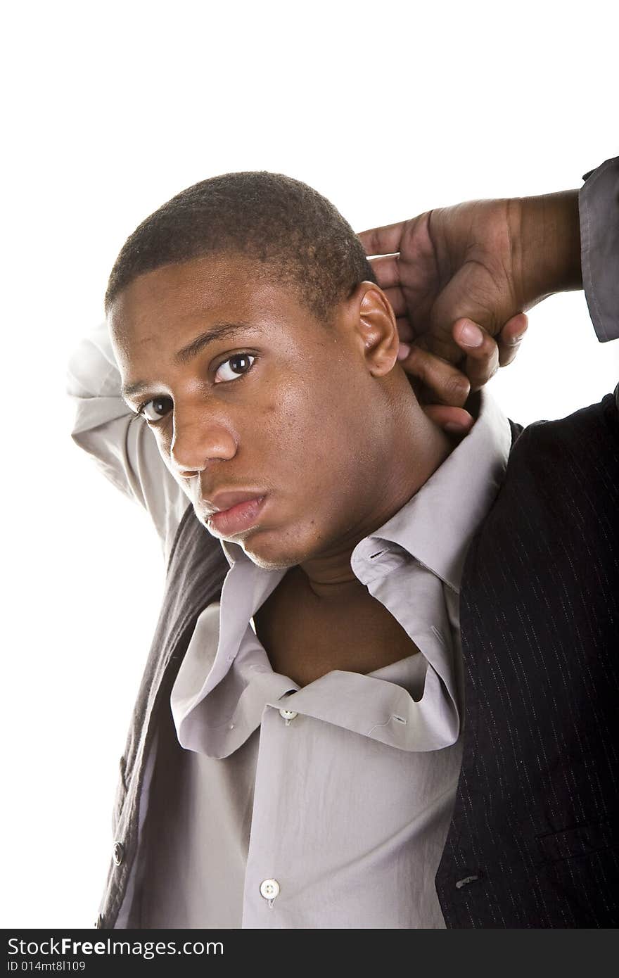 A young black man in grey and black with his hands behind his head in a casual pose. A young black man in grey and black with his hands behind his head in a casual pose