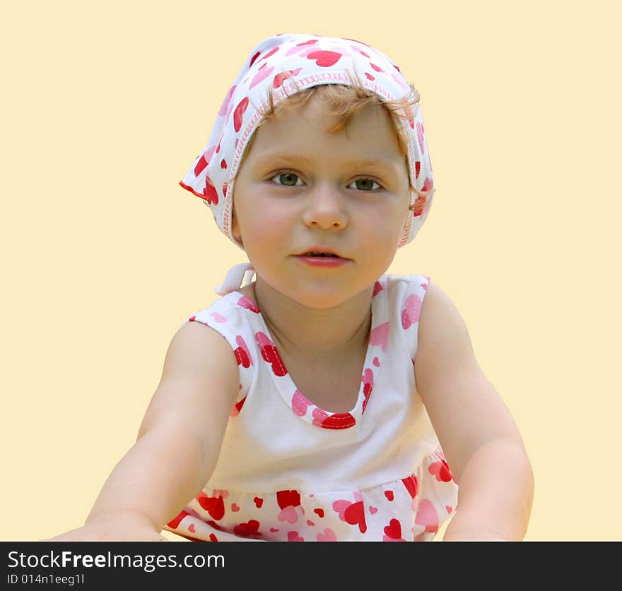 A little girl lies on the floor. a child is isolated on a yellow background