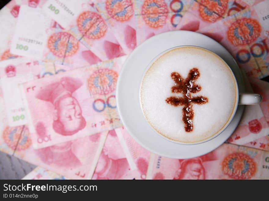 Cup of cappucino with RMB sign on money(RMB)