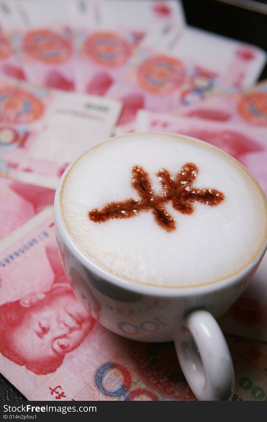 Cup of cappucino with RMB sign on money(RMB)