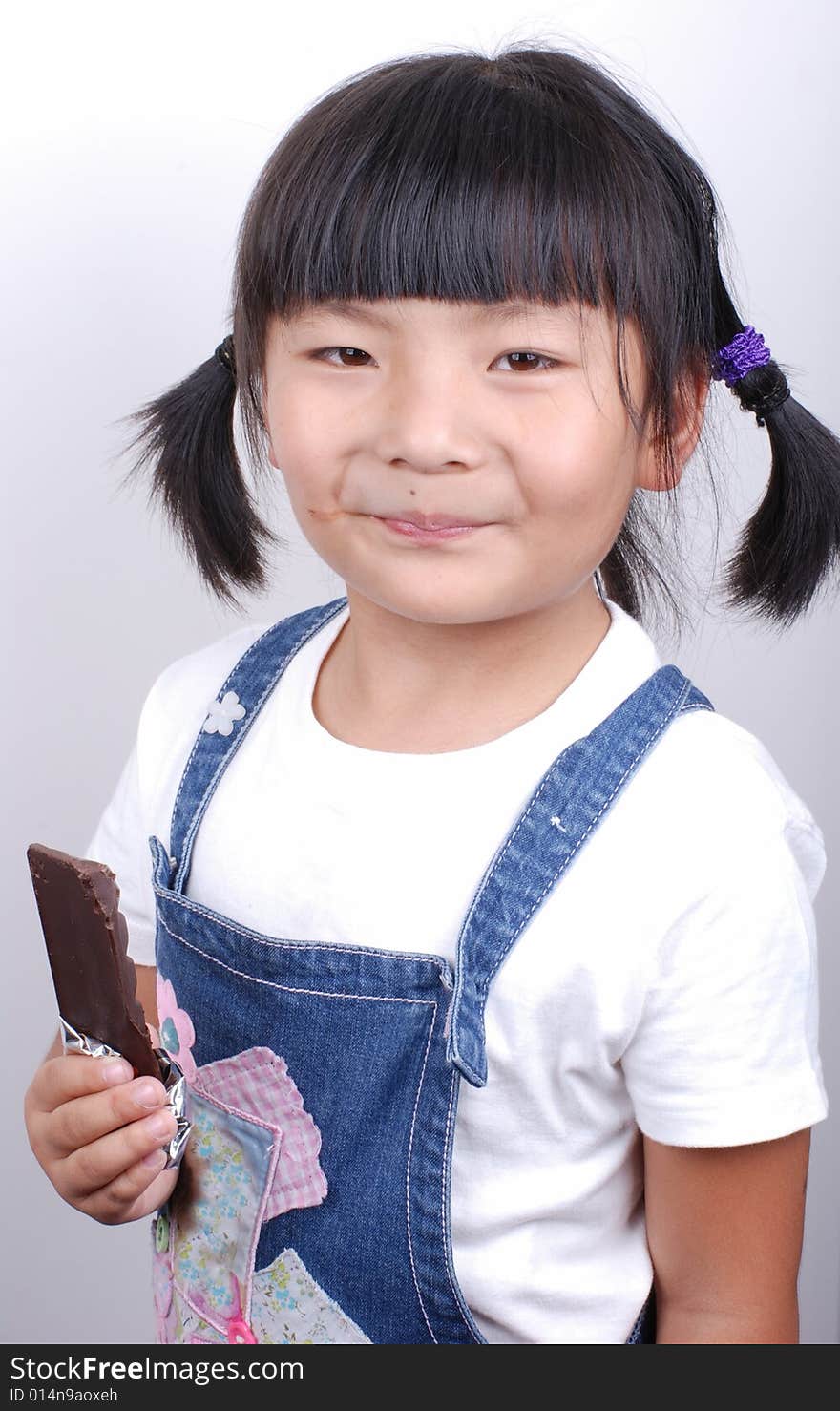 Asia girl eating chocolate