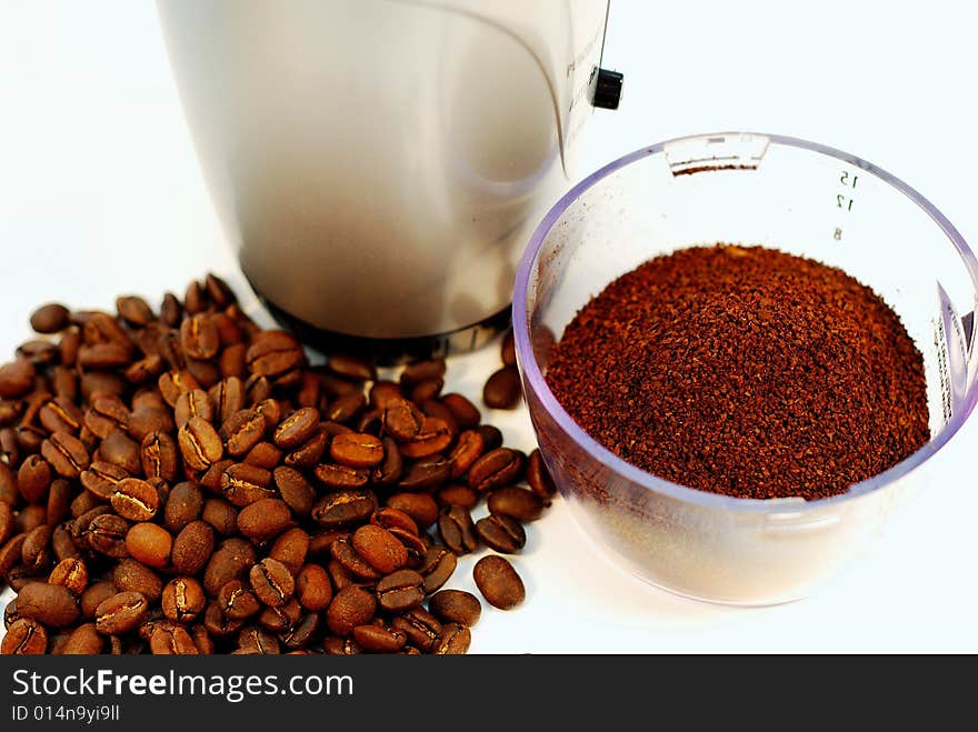 This is a shot of fresh ground coffee and some coffee beans. This is a shot of fresh ground coffee and some coffee beans.