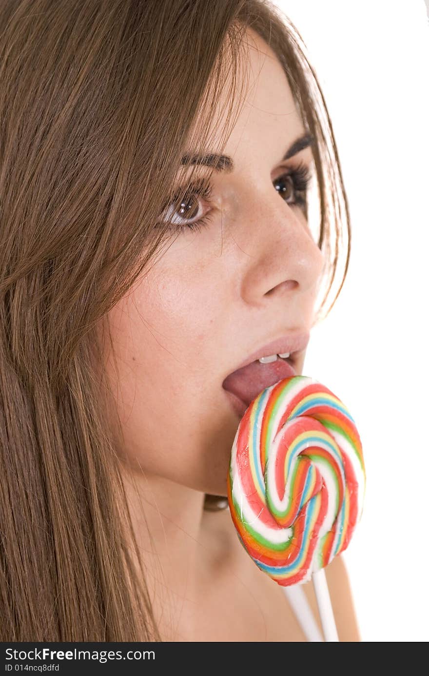 Girl licking her lollipop isolated on white