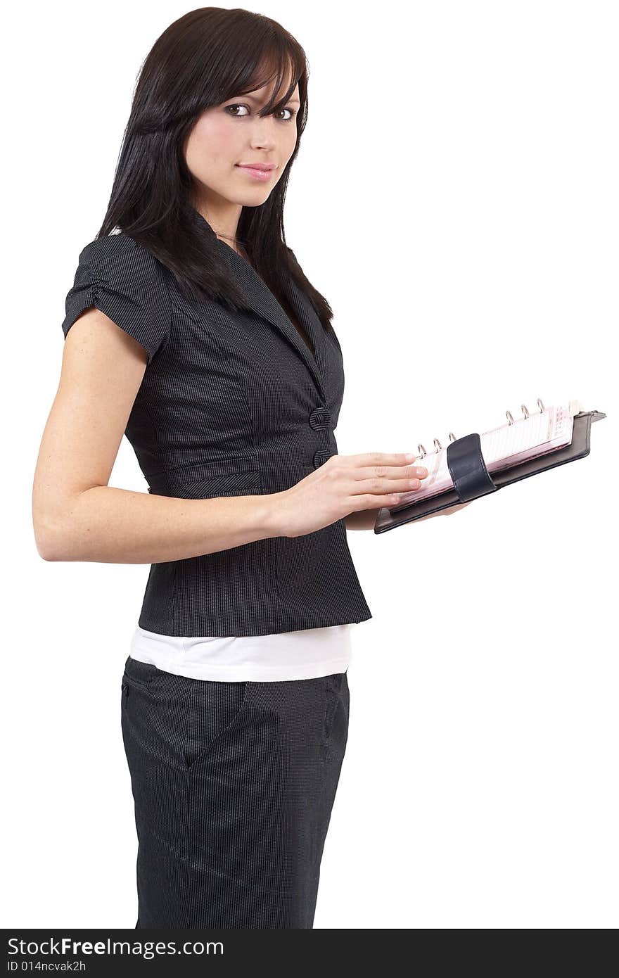 Beautiful young brunette businesswoman wearing a black jacket holding her diary. Isolated on white background with copy space. Beautiful young brunette businesswoman wearing a black jacket holding her diary. Isolated on white background with copy space