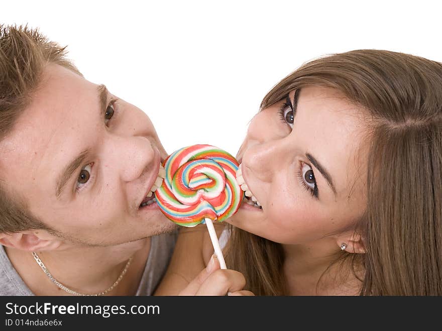 Girl and a guy licking lollipop together