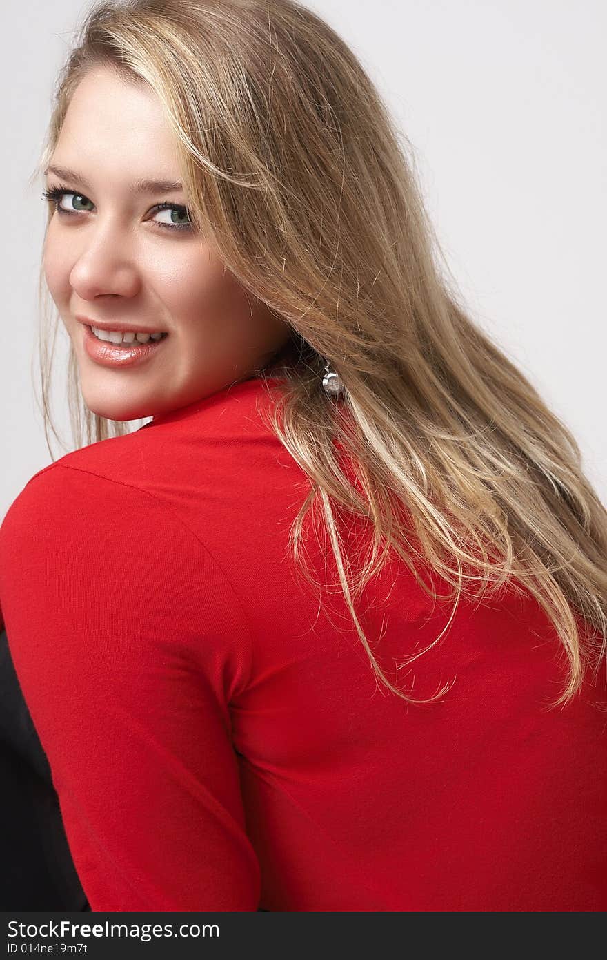 Portrait of beautiful blonde woman wearing a red top. Not isolated