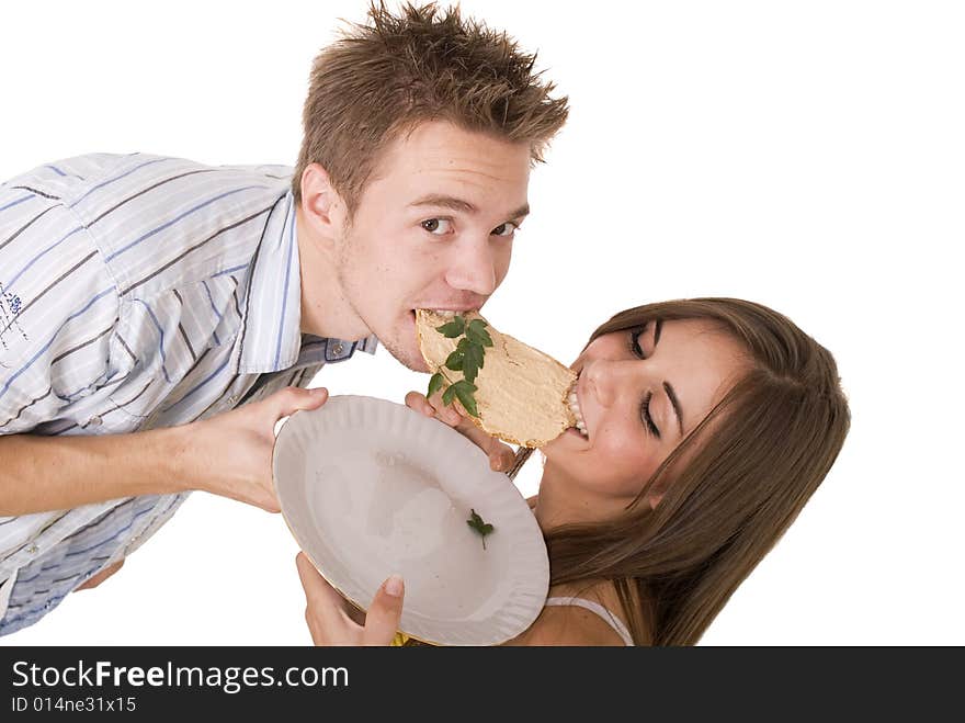 Cute girl and her boyfriend eating a slice of bread. Cute girl and her boyfriend eating a slice of bread