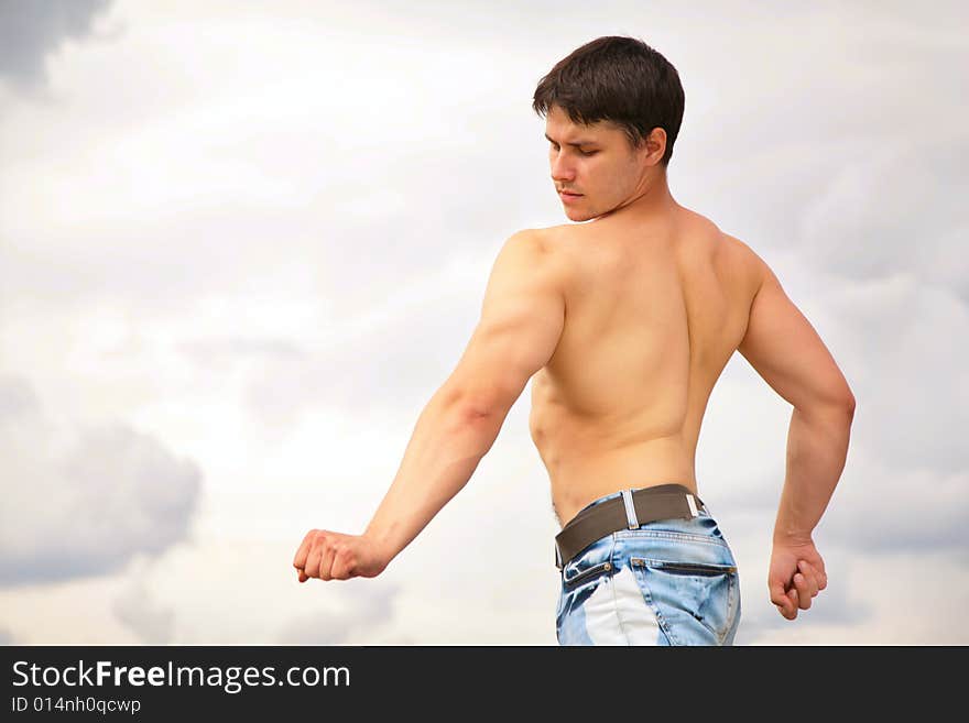 Young Bodybuilder On Cloudy Background