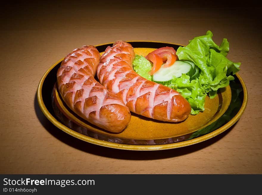 Sausages on plate with tomatoes. Sausages on plate with tomatoes