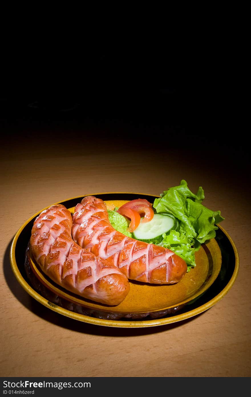 Sausages on plate with salad. Sausages on plate with salad