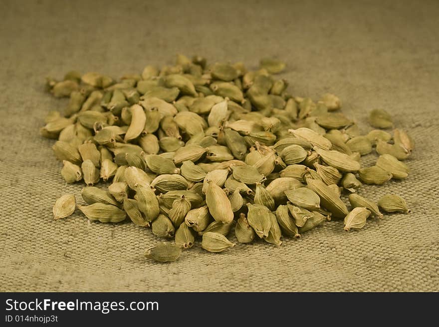 Green cardamom fruits on burlap