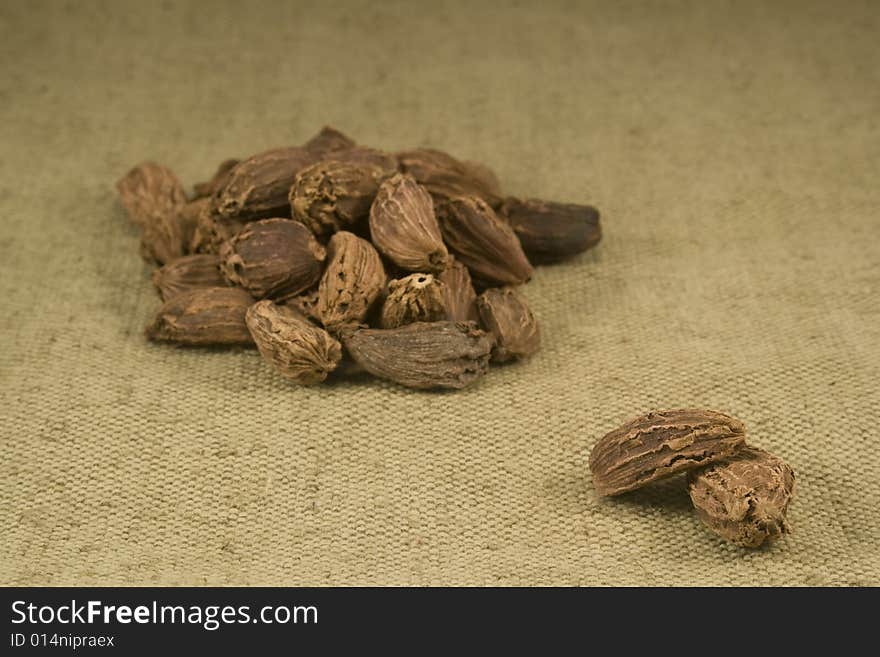 Black cardamom fruits on burlap