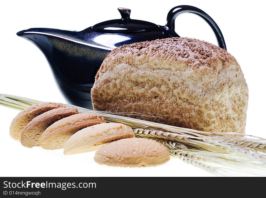 Pastry, wheat, bread and teapot on white. Pastry, wheat, bread and teapot on white