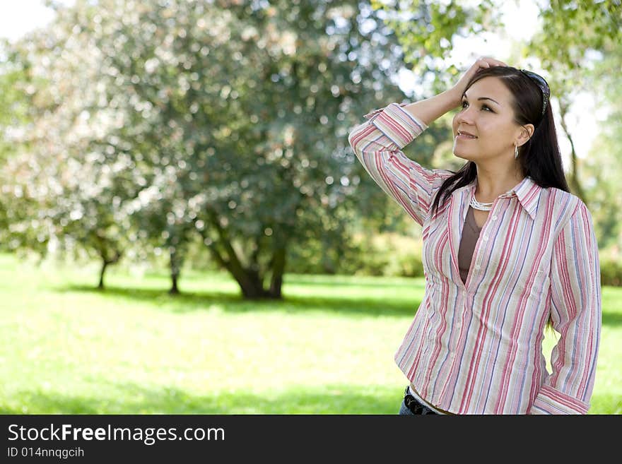 Attractive brunette woman in park. Attractive brunette woman in park