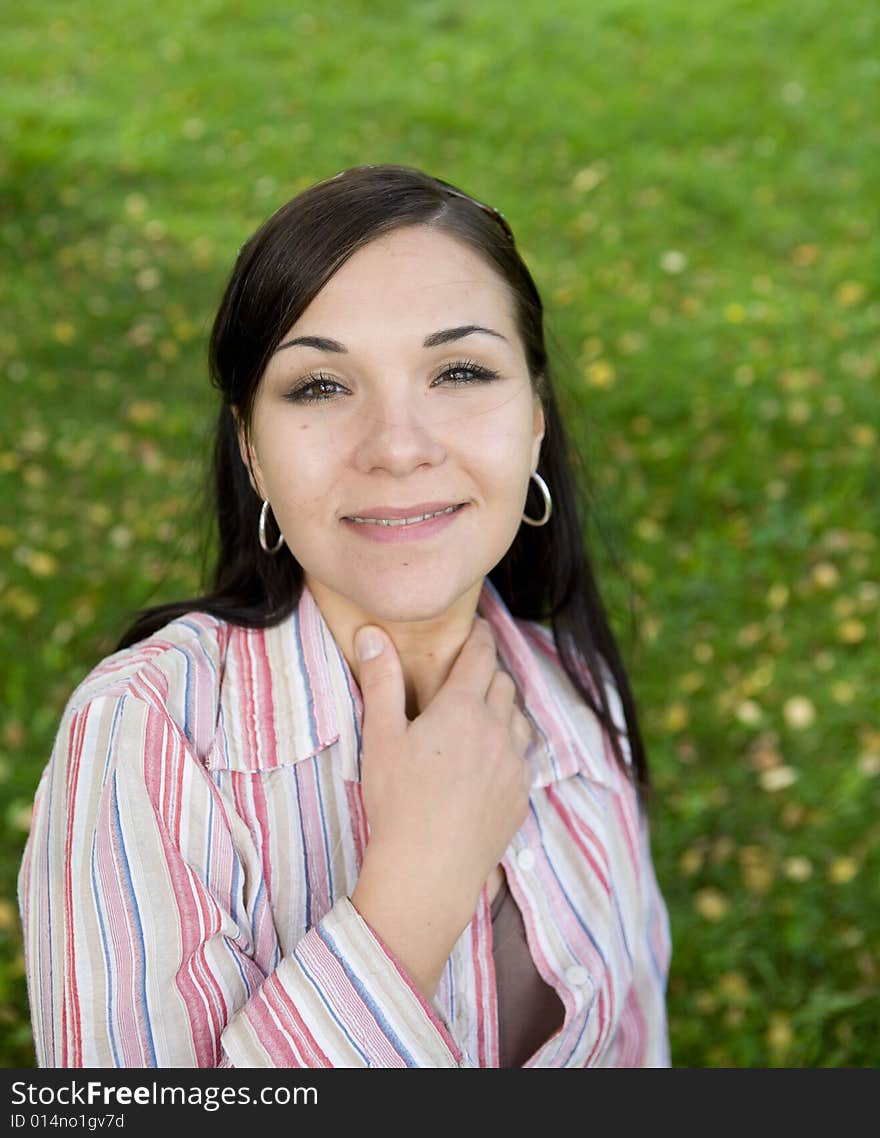 Attractive brunette woman in park. Attractive brunette woman in park