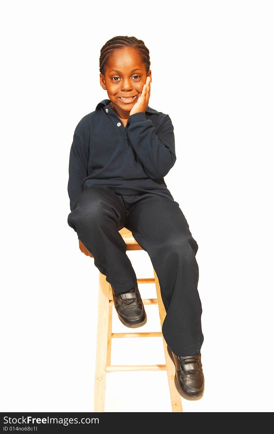 A friendly young Jamaican boy in the studio sitting on an bar chair and 
wondering what is going on around him. A friendly young Jamaican boy in the studio sitting on an bar chair and 
wondering what is going on around him.