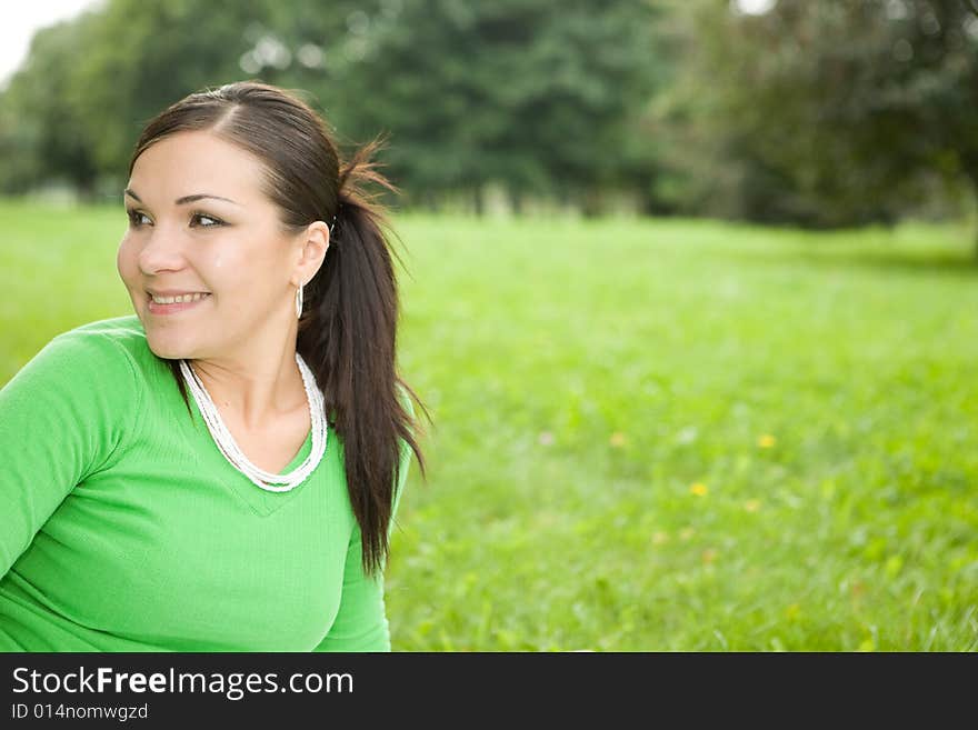 Attractive brunette woman in park. Attractive brunette woman in park