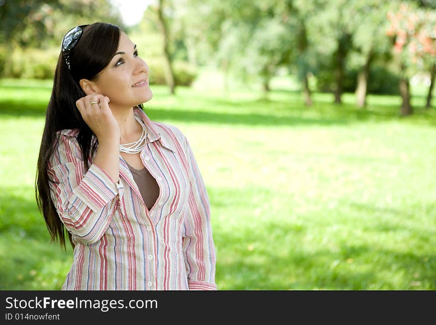 Attractive brunette woman in park. Attractive brunette woman in park