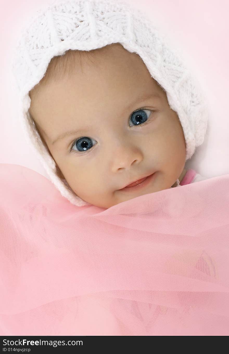 Portrait of the little girl in a knitted hat