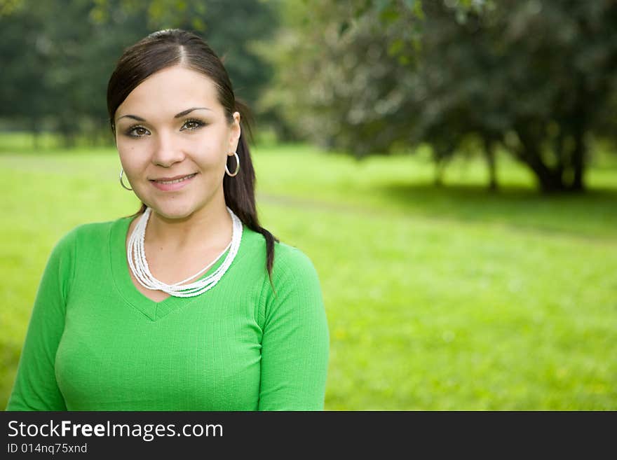 Attractive brunette woman in park. Attractive brunette woman in park