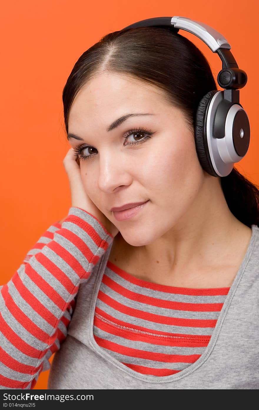 Attractive brunette woman with headphones. Attractive brunette woman with headphones