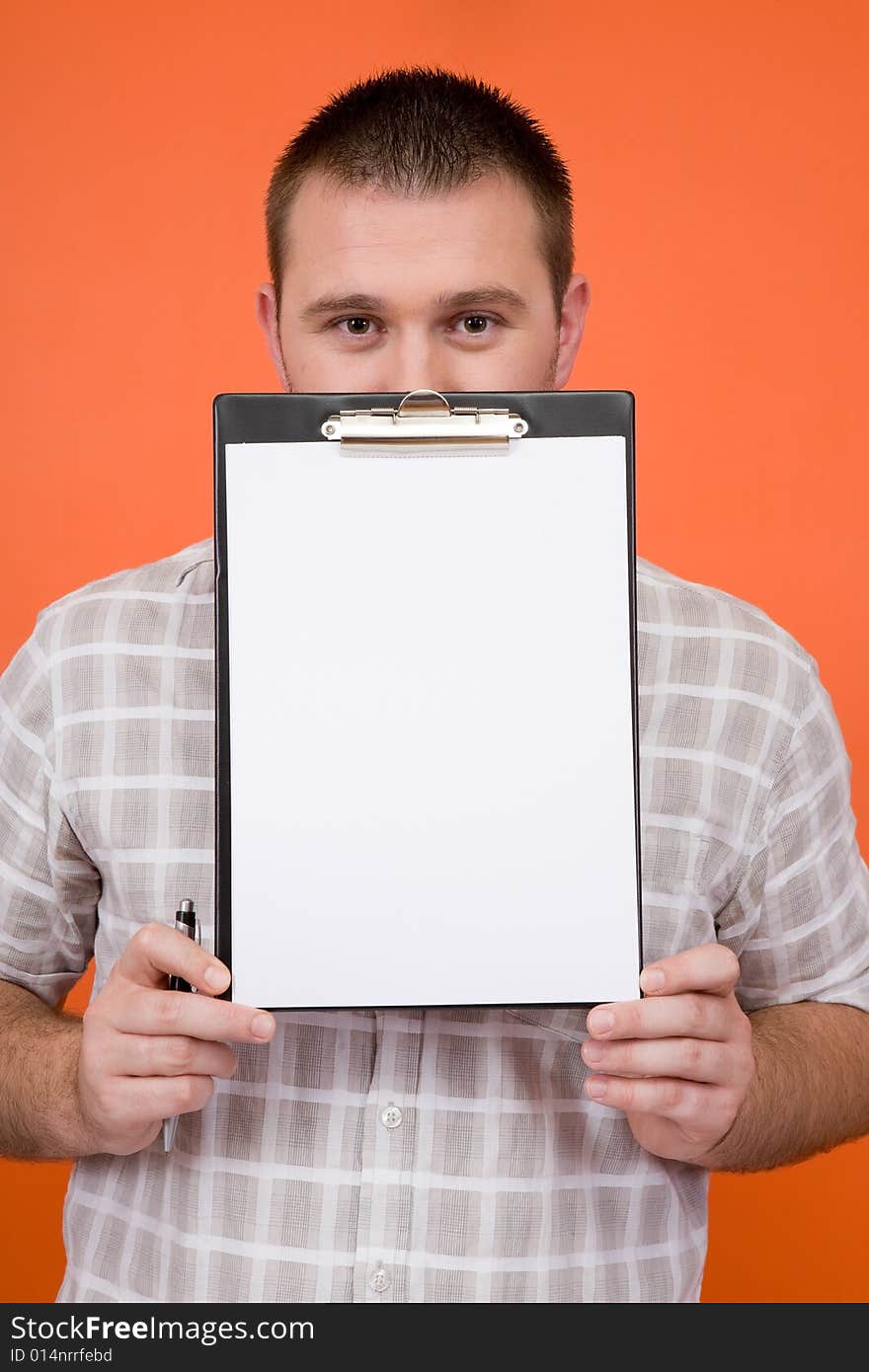 Casual guy standing with banner on orange background. Casual guy standing with banner on orange background