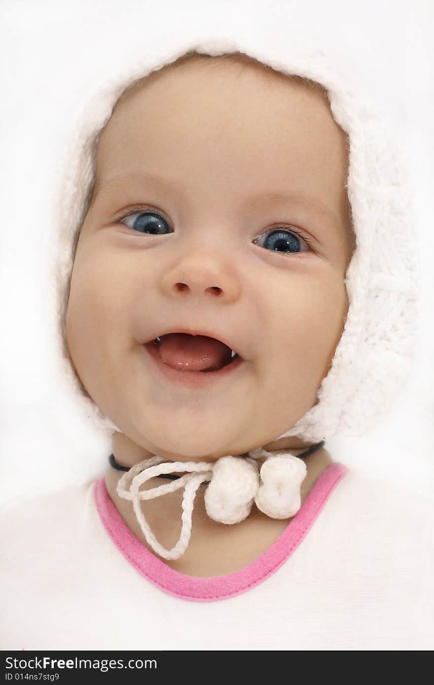 Portrait of the little girl in a knitted hat