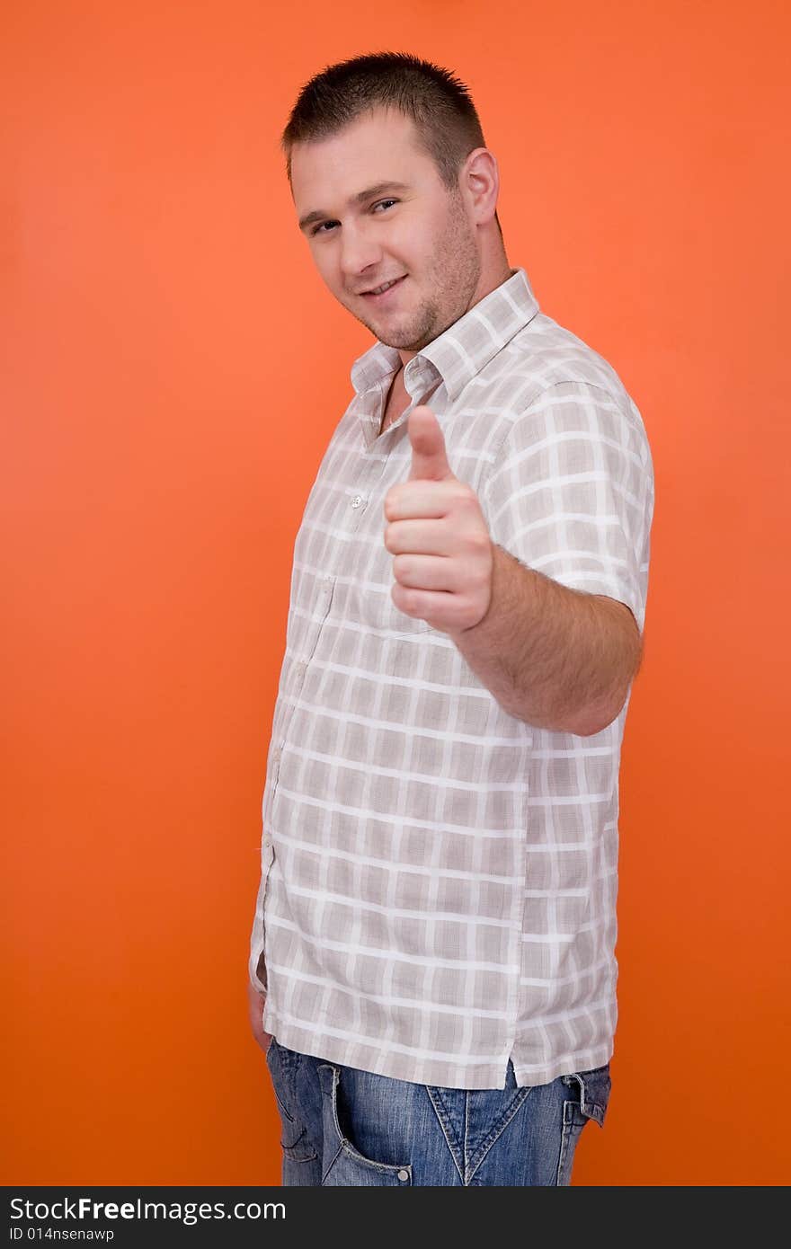 Casual student standing on orange background