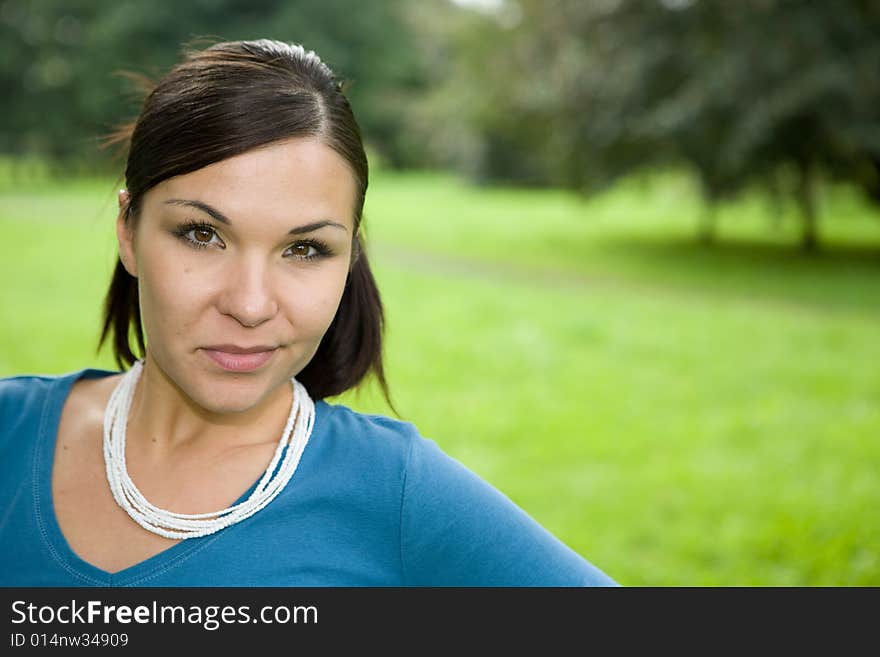 Attractive brunette woman in park. Attractive brunette woman in park