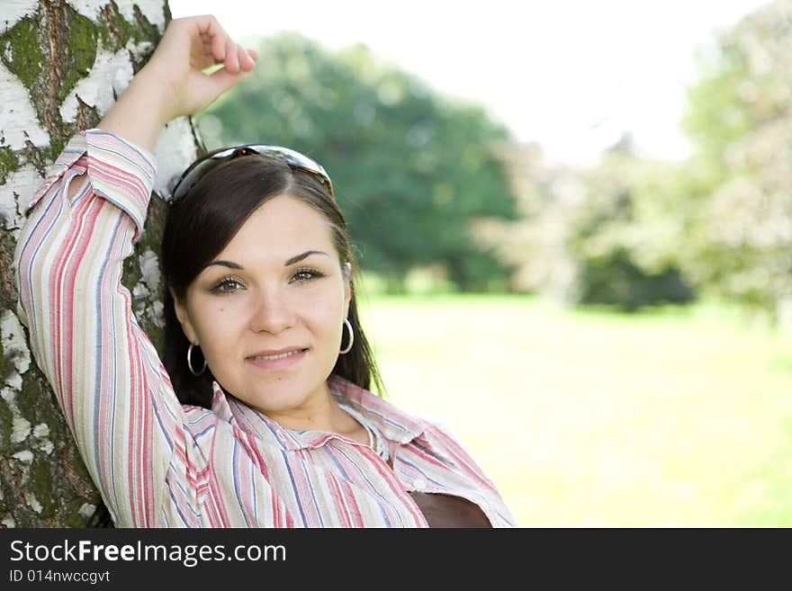 Attractive brunette woman in park. Attractive brunette woman in park