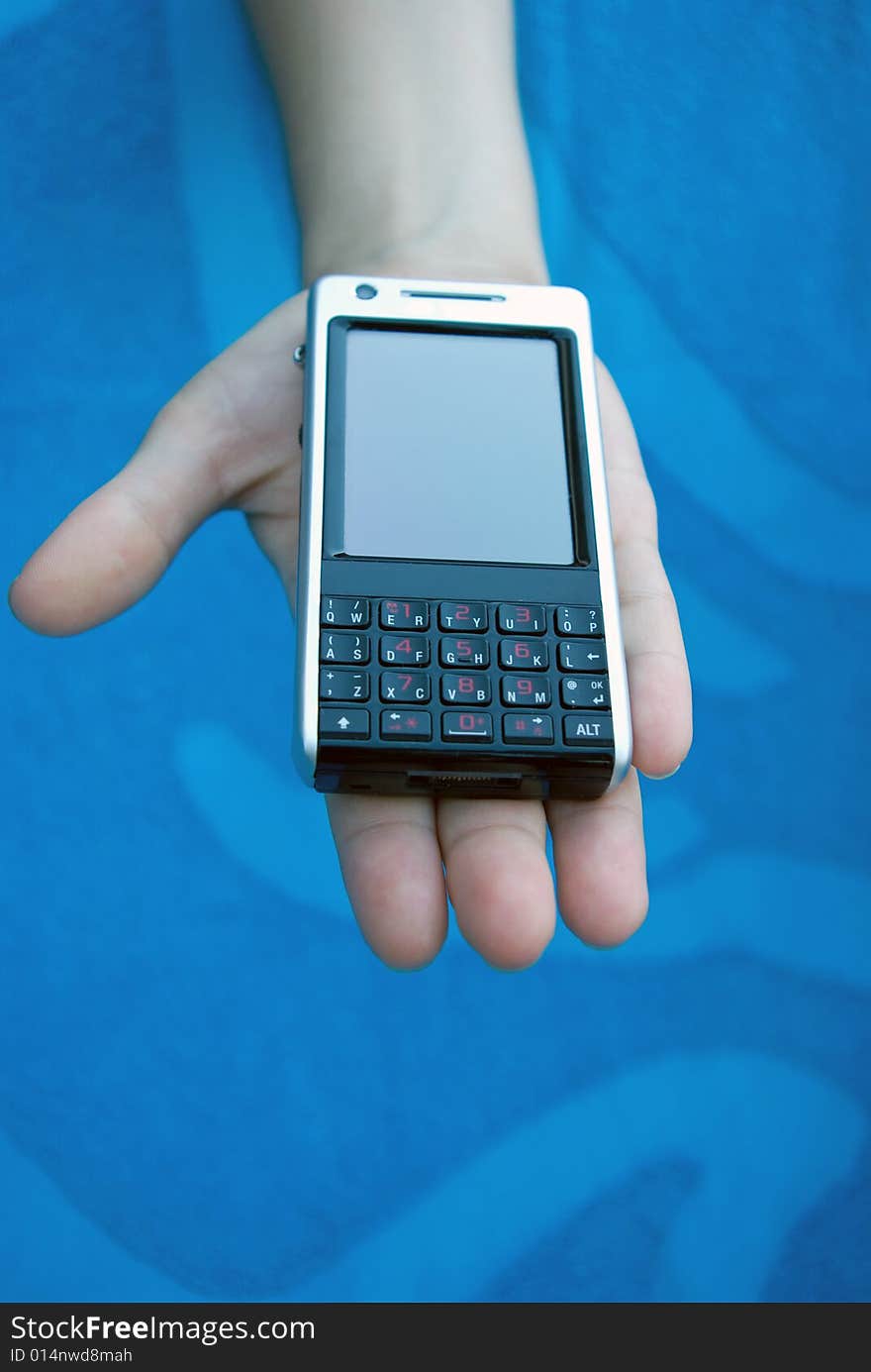 Cellular (mobile) phone on girl's palm reaching forward. Cellular (mobile) phone on girl's palm reaching forward