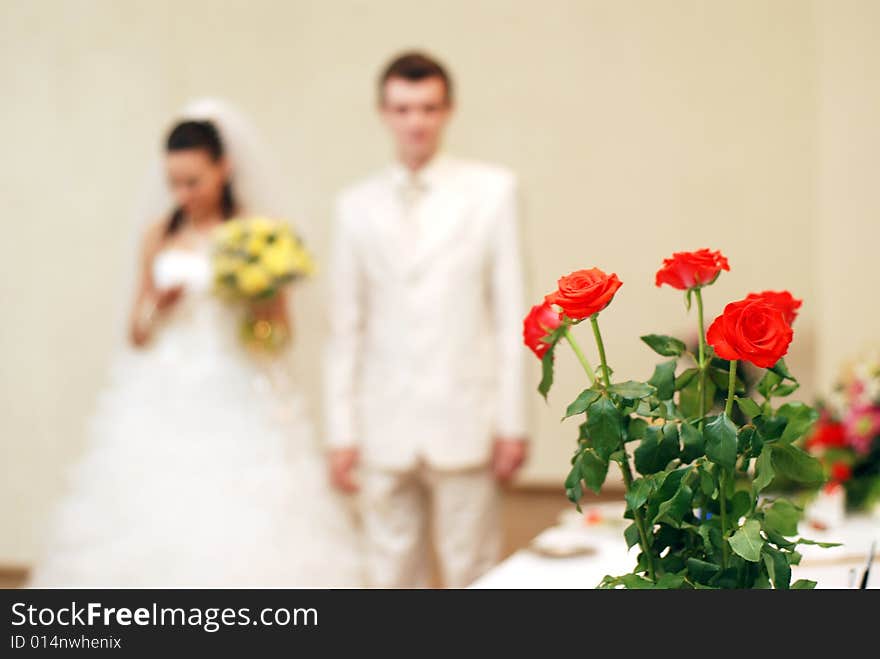 Bunch of white roses and newly-weds on a background. Bunch of white roses and newly-weds on a background