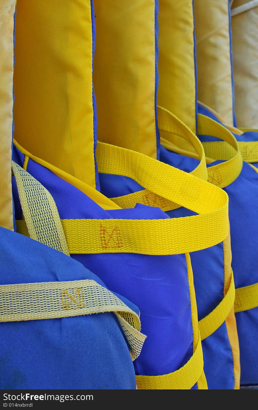 Row of life jackets on marina