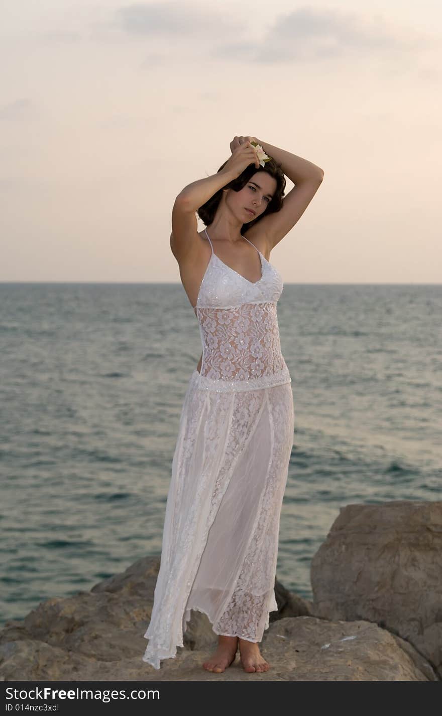 Young woman staying on the rock