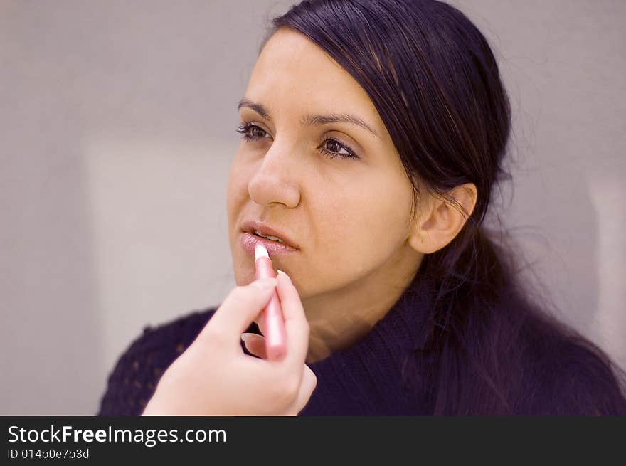 Young woman being make up by a makeup artist. Young woman being make up by a makeup artist.