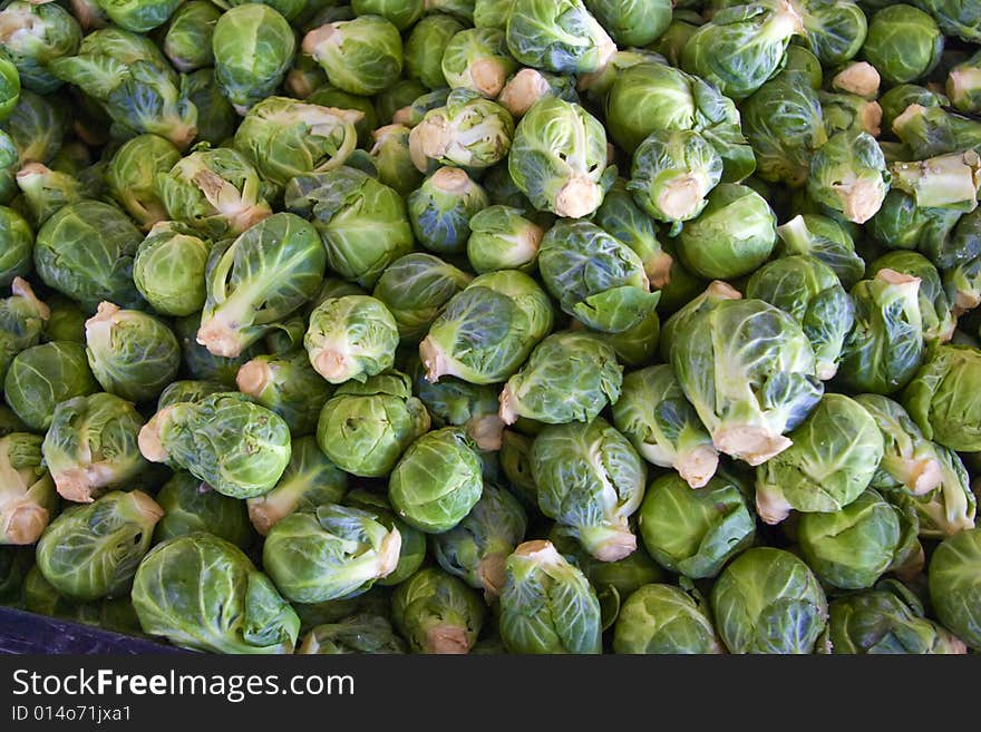 A bin full of fresh brussel sprouts at a local farmers' market