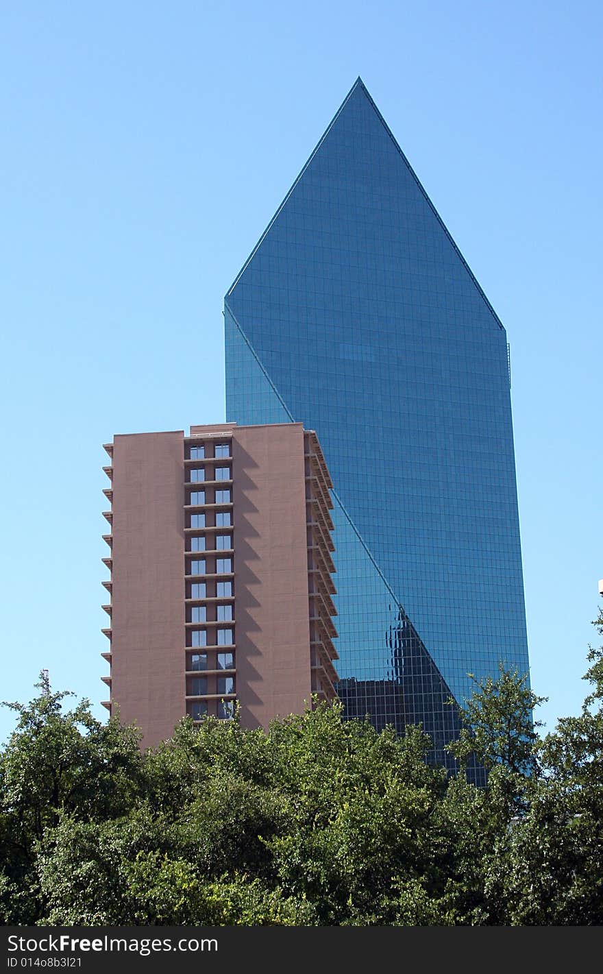 An apartment and a modern skyscraper stand next to each other. An apartment and a modern skyscraper stand next to each other.